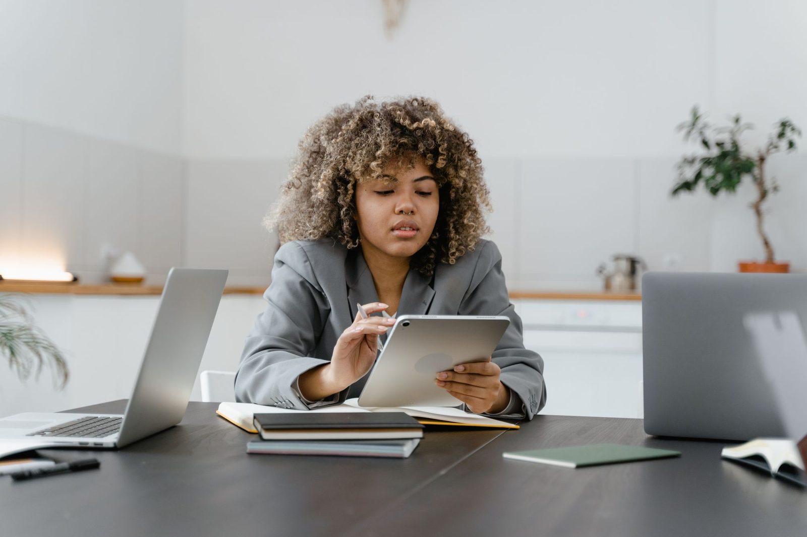 Professional reviewing work on a tablet at her desk